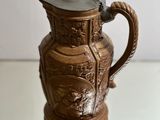 a brown vase that is sitting on a glass table
