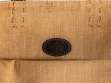 a close up of a brown bag with a black leather handle