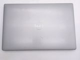 dell laptop computer sitting on a white surface with a logo on the screen