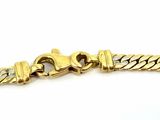 a close up of a gold bracelet on a white background