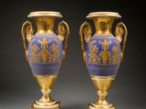 pair of blue and gold vases with handles on stands