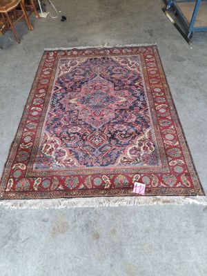rug on the floor in the middle of a room with chairs and a table