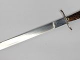 a close up of a knife with a wooden handle on a white surface