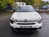 a white car that is parked on the side of the road