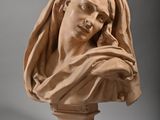marble bust of a woman with a veil on her head