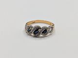 a close up of a gold ring with a blue stone