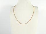 a white mannequin torso with a gold chain on it