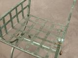 a metal chair that has a basket on the back