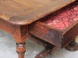 a wooden table with a drawer underneath it