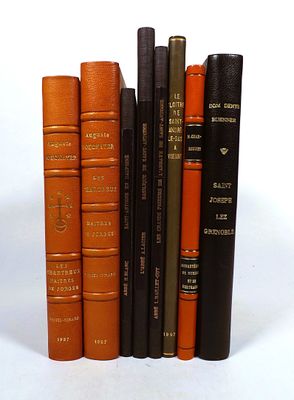many books that are lined up on a white surface