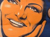a poster of a woman smiling with her hand on her face