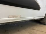 a close up of a white car with a sticker on it