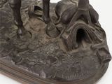 bronze statue of a man on a horse with a man laying on the ground