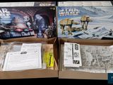 two boxes of star wars action toys sit in a cardboard box