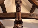 a wooden sculpture on top of a wooden structure