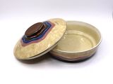 a small bowl with a lid sitting on a table