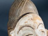 a close up of a statue of a person with a hat on