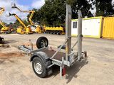 a trailer with a crane attached to it in a parking lot