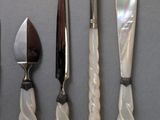 five different types of knives and knives on a table