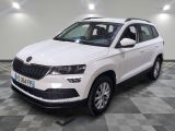 the white skoda is parked on a checkered tile floor