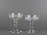 pair of clear glass goblets on a grey background