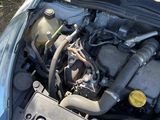 the engine of a car with its hood open on the grass