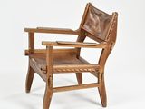 an image of a wooden chair with a brown leather seat