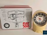 a yellow watch sitting next to a box with a picture of a plane