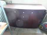 a wooden cabinet in the corner of a room