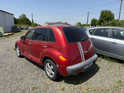 a red car parked next to a silver car in a parking lot