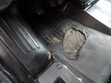 a hole in the floor of a car that has been damaged