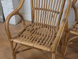 pair of rattan chairs in the shape of a pair of chairs