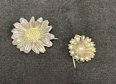 pair of silver and gold tone flower brooches