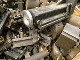 a large pile of old metal parts in a bin