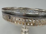 a silver plate with a decorative design on it