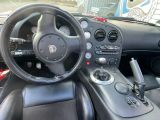 a steering wheel and dashboard of a sports car