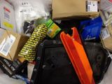 a pile of assorted items in a bin on the floor