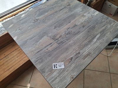 a picture of a piece of wood sitting on a tile floor