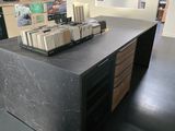 a black counter top with a bunch of books on top of it
