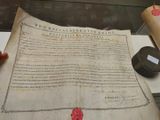 a large piece of paper with a wax seal on it