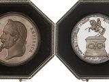 three different types of silver and bronze coins in a display case