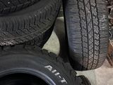 tires are stacked on the floor next to a pile of other tires