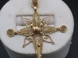an image of a gold cross on a white marble box