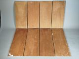several pieces of wood are stacked on top of each other on a white surface