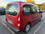 a red van parked in a parking lot next to other cars