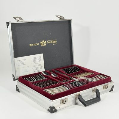 silverware in a silver case on a white surface