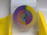 a picture of a disc in a box with a piece of paper in it
