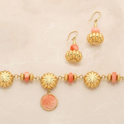 an image of a necklace and earring set with a coin