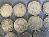 several different types of coins are arranged on a table