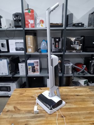 a table with a phone on it and a lamp on it